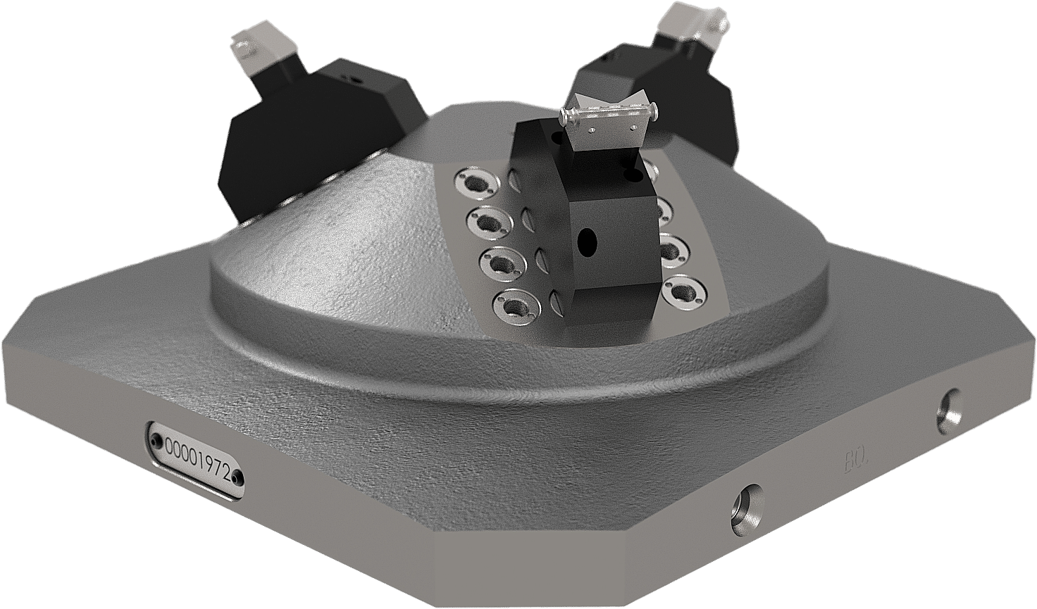 A metallic hexagonal industrial part with bolts, three black clamps on a sloped matte surface, and a small serial number plate.